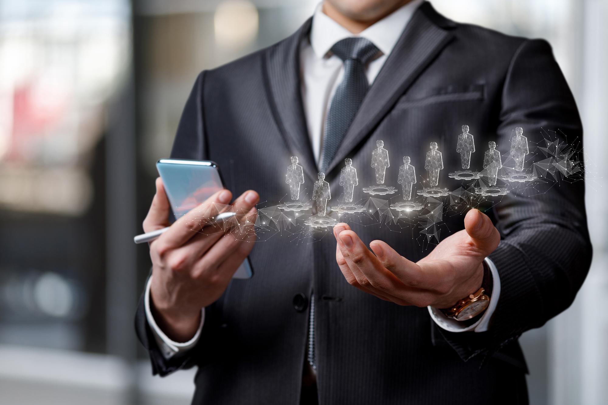businessman-shows-his-hands-hologram-human-resources-blurred-background_1035553-203