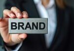 businessman-holding-gray-box-with-word-brand_882868-598